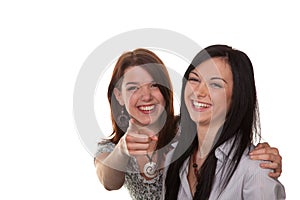 Two young women breaking into laughter