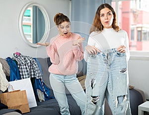 Two young women choosing clothes to wear