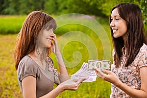 Two young women concluding bargain