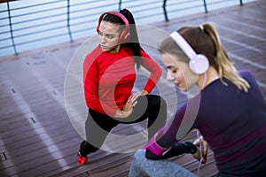 Two young women doing gymnastic exercises outdoor