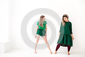 Two young women doing yoga indoo photo