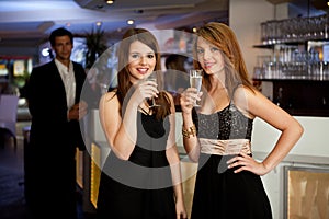 Two young women drinking chanpagne