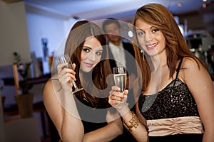 Two young women drinking chanpagne