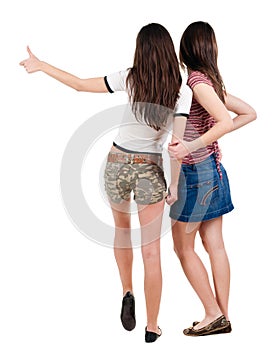 Two young women friends showing thumbs up