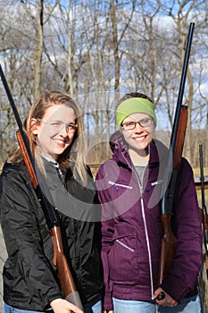 Two young women with guns at trap shooting range
