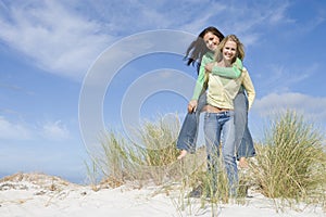 Two young women having fun in dunes