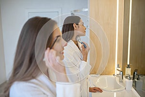 Two young women having spa weekend and doing make up