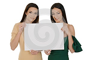 Two young women holding blank board