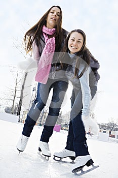 Two young women on ice rink