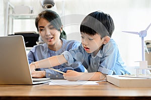 Little kid son interrupting mother's working at home