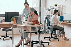 Two young women looking at laptop monitor