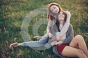 Two young women lying on the grass