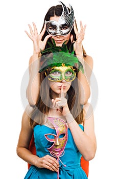 Two young women in masks make hush sign photo