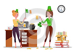 Two young women office workers celebrate St. Patrick`s Day at workplace with beer mugs, Ireland flag in hands. Piles of paper