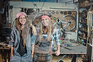 two young women posing in a workshop