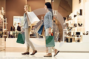Two young women are shopping at mall.