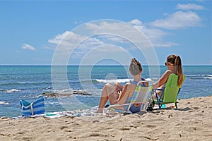 Two young women sunbathing on a beach on Oahu, Hawaiilu