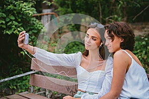 Two young women taking a photo