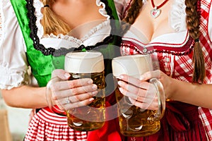 Two young women in traditional Bavarian Tracht in restaurant or pub