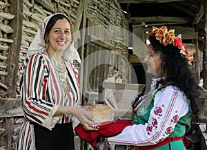 Two young women in traditional Bulgarian folklore costumes