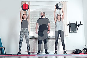 two young women training at home with personal trainer