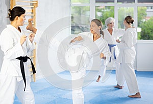 Two young women training karate techniques