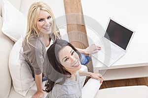 Two Young Women Using Laptop Computer Home Sofa