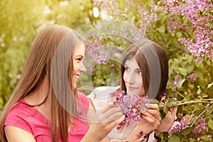 Two young women walking outside in a park