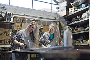 two young women working in workshop