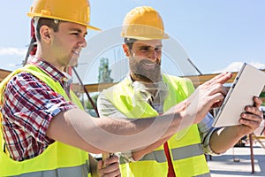 Two young workers watching a video or communicating online throu