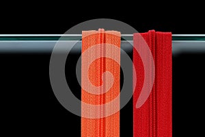 Two zipper in different colors orange and red