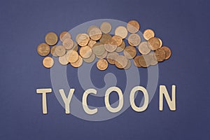 Tycoon written with wooden letters on a blue background photo