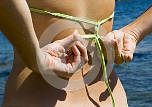 Tying a bikini