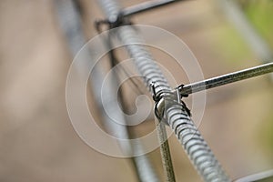Tying reinforcing steel bars for formwork construction