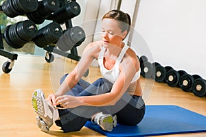 Tying shoelaces before training in gym