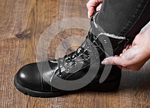 Tying Shoes on wooden floor