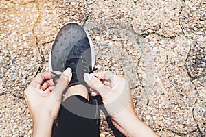 Tying sport shoes, Asian woman getting ready for running, Outdoor sport