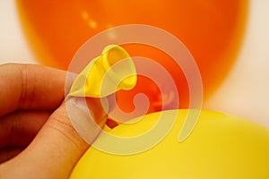 Tying yellow balloon
