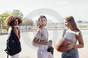 tylish cool teen girls gathering at basketball court, friends ready for playing basketball outdoors