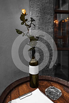 Tyn Yard Ungelt. Old Town Prague, Czech Republic. Rose in wine bottle on wooden barrel