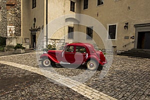 Tyniec, Krakow, Poland, August 3, 2019: Old, antique red car used to transport newlyweds at the wedding,