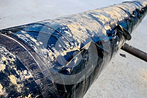 Type of insulation against corrosion of large metal pipe. Black pipe winding for gasification. Background
