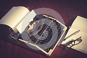 Typewriter with book,eyeglasses and pen