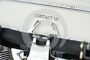 Typewriter with Contact Us text photo