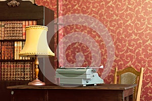 Typewriter, lamp, books