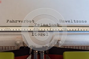 Typewriter with a leaf and the words Fahrverbot, Umweltzone, Feinstaub und Diesel Driving Ban, Environmental Zone, Particulate