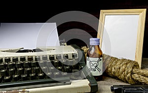 Typewriter with paper page and poison and gun.