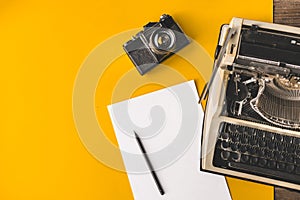 Typewriter, Vintage Film Camera, Sheet Of Paper And Pencil On A Yellow Background, Top View. Creative writing concept