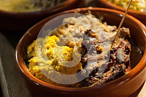 Typica food with meat and polenta at the traditional