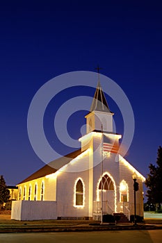 Typical american church with flag and blue sky